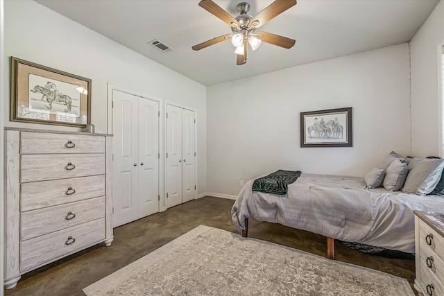 bedroom with multiple closets and ceiling fan