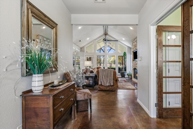 entryway with a stone fireplace, ceiling fan, lofted ceiling with beams, and dark hardwood / wood-style floors