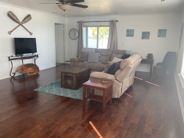 living room featuring ceiling fan, dark hardwood / wood-style flooring, and crown molding