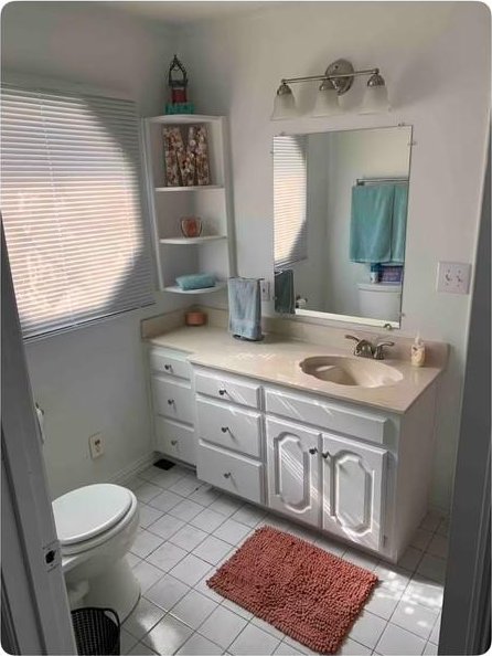 bathroom featuring tile patterned flooring, vanity, and toilet