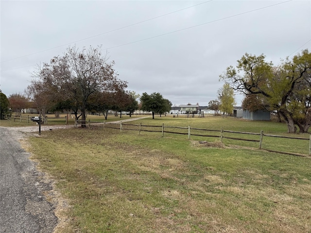 view of yard with a rural view