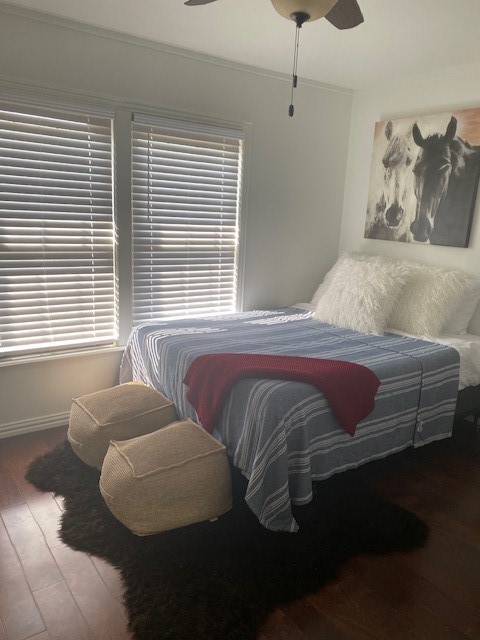 bedroom with ceiling fan, crown molding, and hardwood / wood-style flooring