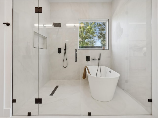 bathroom featuring independent shower and bath and tile walls