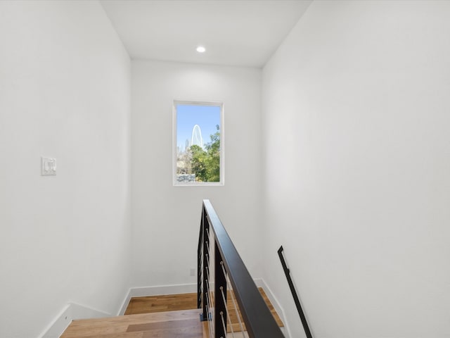 stairs featuring wood-type flooring