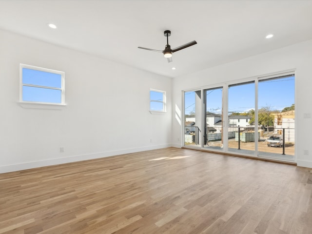 unfurnished room with ceiling fan and light hardwood / wood-style flooring