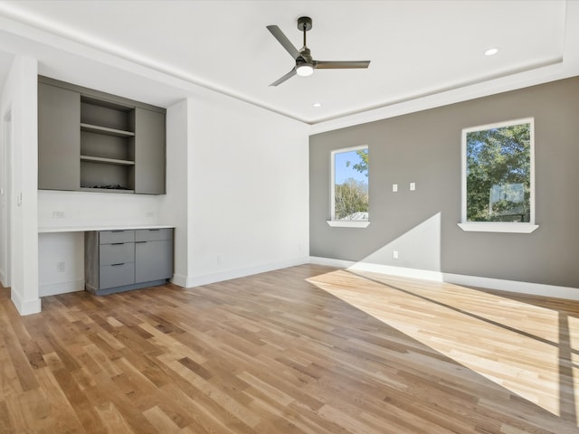 unfurnished living room with ceiling fan and light wood-type flooring