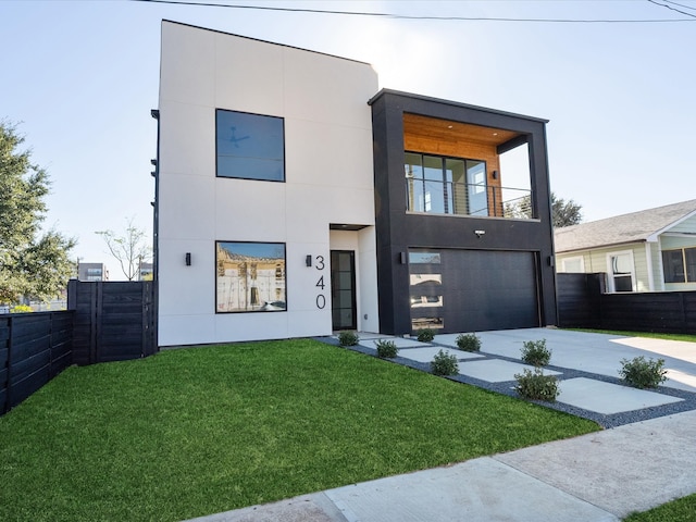 contemporary home with a garage, a balcony, and a front lawn