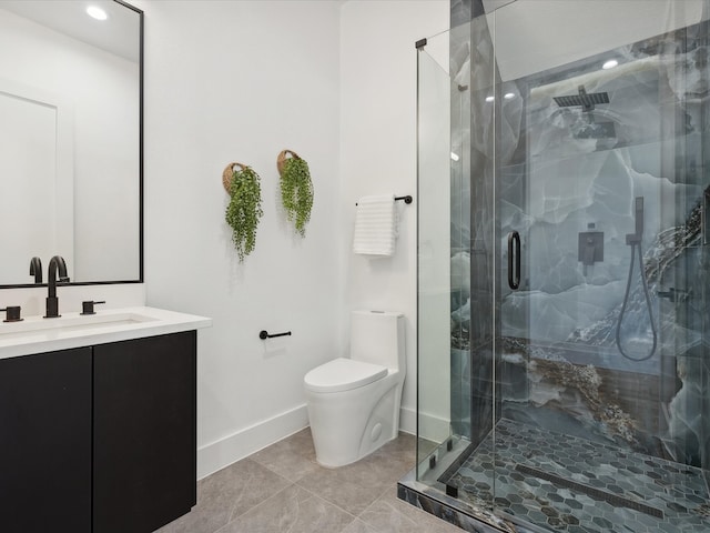 bathroom featuring tile patterned floors, a shower with door, vanity, and toilet