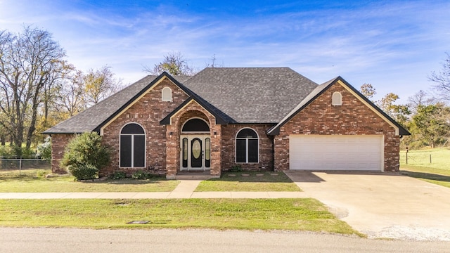 view of front of property with a front yard and a garage