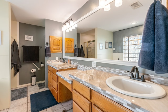 bathroom featuring tile patterned floors, decorative backsplash, vanity, and an enclosed shower