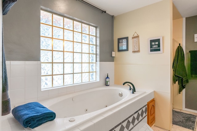 bathroom featuring tile patterned floors and tiled tub