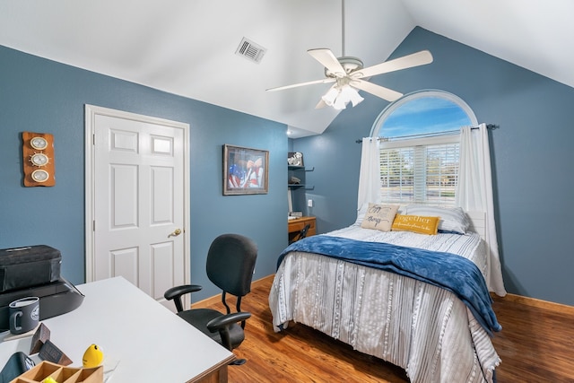 bedroom with ceiling fan, dark wood-type flooring, and vaulted ceiling