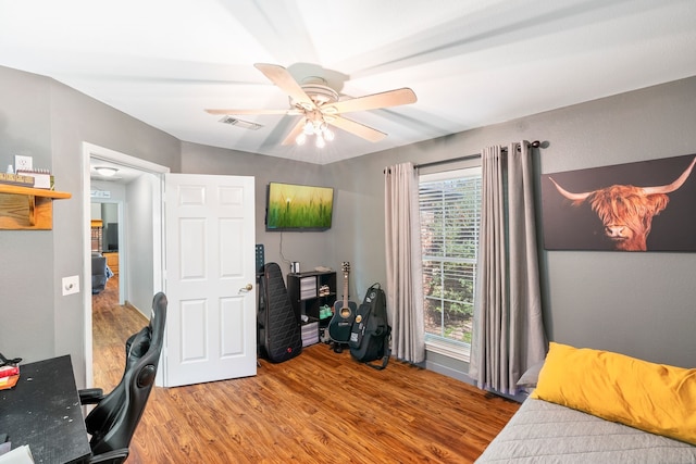 bedroom with ceiling fan and wood-type flooring