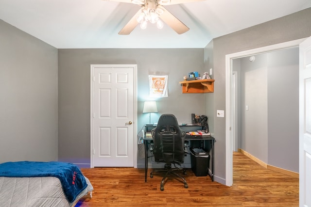 bedroom with ceiling fan, baseboards, and wood finished floors