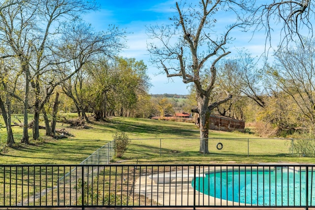 view of swimming pool with a lawn