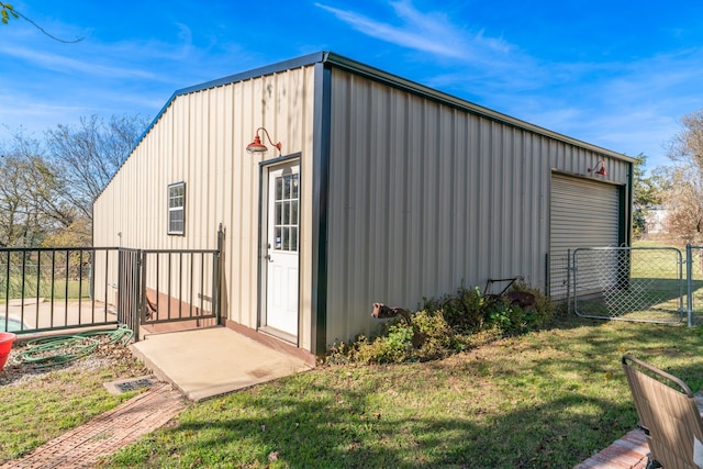 view of outdoor structure featuring a yard and a garage