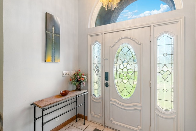 entrance foyer featuring light tile patterned floors and a chandelier