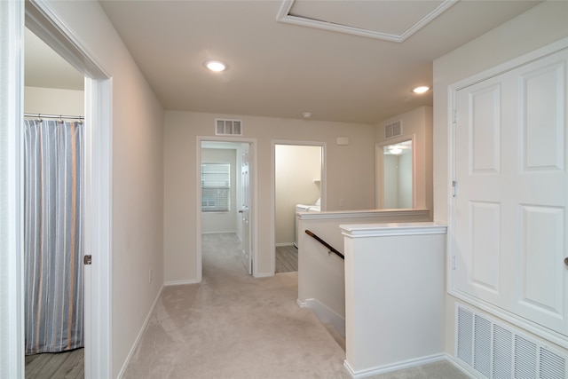 hallway featuring light carpet