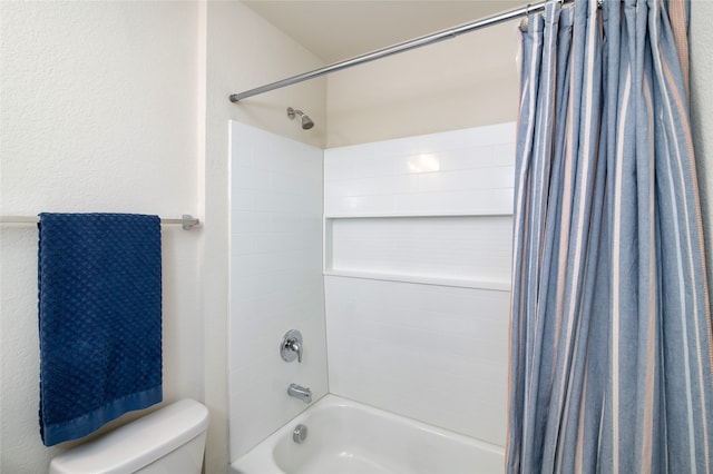 bathroom featuring shower / bath combination with curtain and toilet