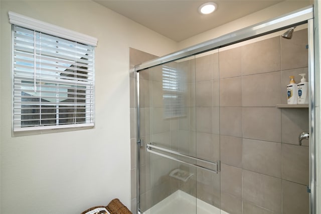 bathroom featuring a shower with door