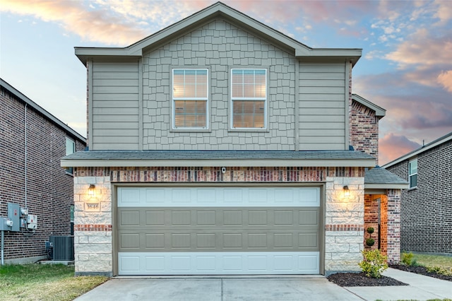 front of property featuring a garage and central AC