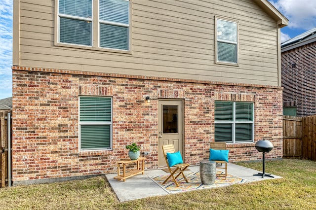 rear view of property featuring a yard and a patio