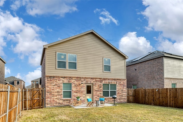 rear view of house with a lawn and a patio area