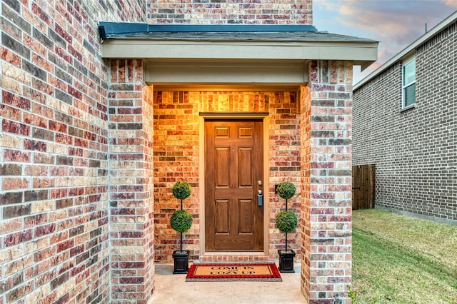 view of exterior entry at dusk