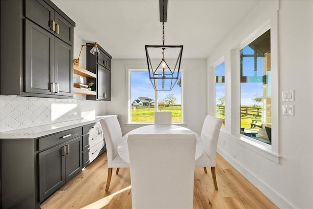 dining area with a chandelier and light hardwood / wood-style floors