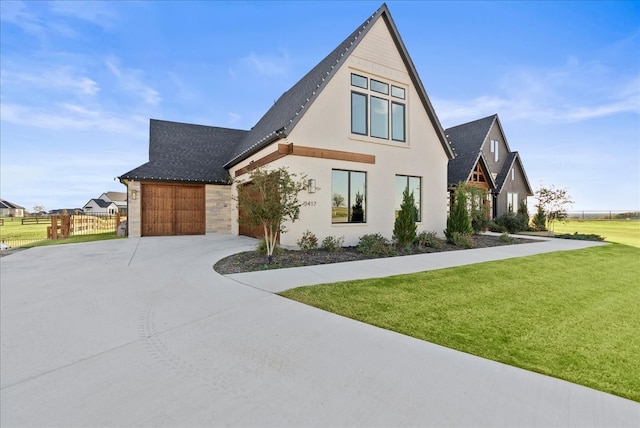 view of front facade featuring a garage and a front lawn