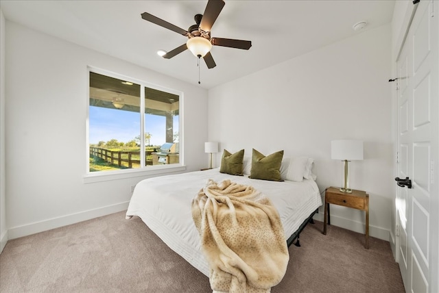 bedroom featuring ceiling fan and carpet