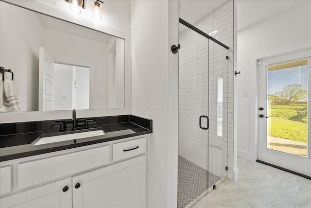 bathroom featuring vanity, a wealth of natural light, and an enclosed shower