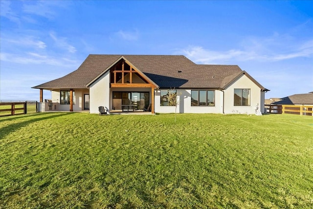 rear view of house with a yard and a patio