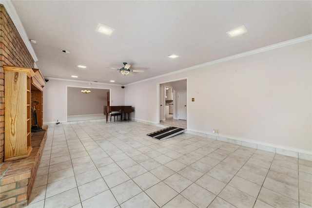 empty room with a textured ceiling, crown molding, ceiling fan, and light tile patterned floors