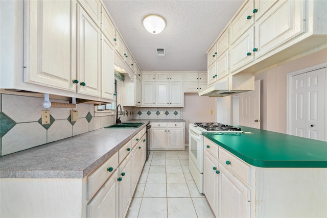 kitchen featuring white gas range, sink, black dishwasher, decorative backsplash, and light tile patterned floors