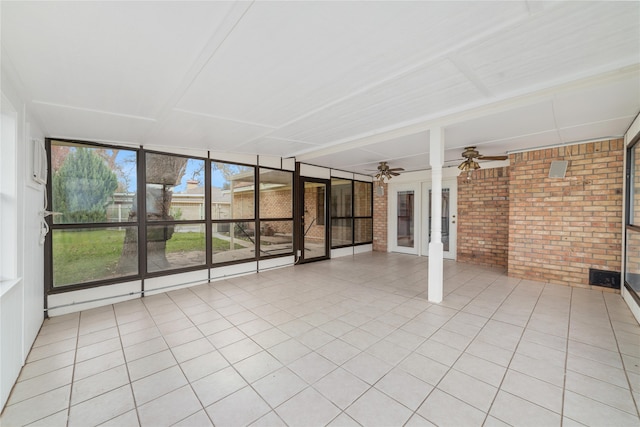 unfurnished sunroom with ceiling fan