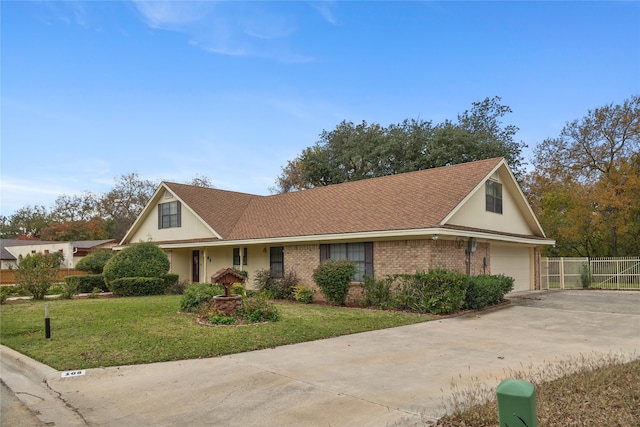 view of front facade with a garage and a front lawn