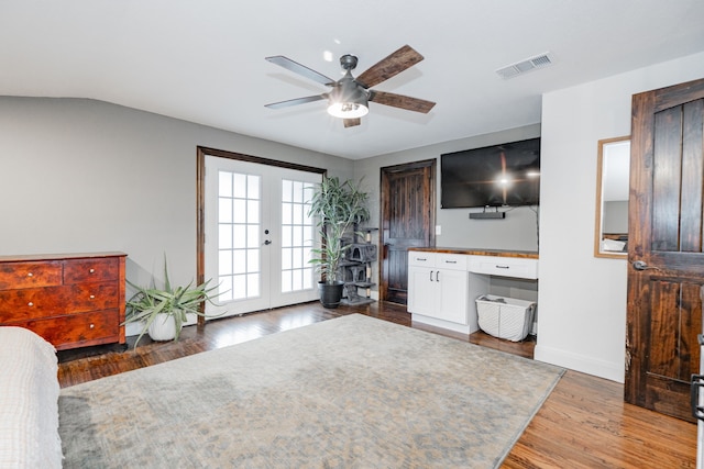 living room with dark hardwood / wood-style floors, ceiling fan, lofted ceiling, and french doors