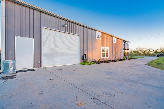 view of garage at dusk