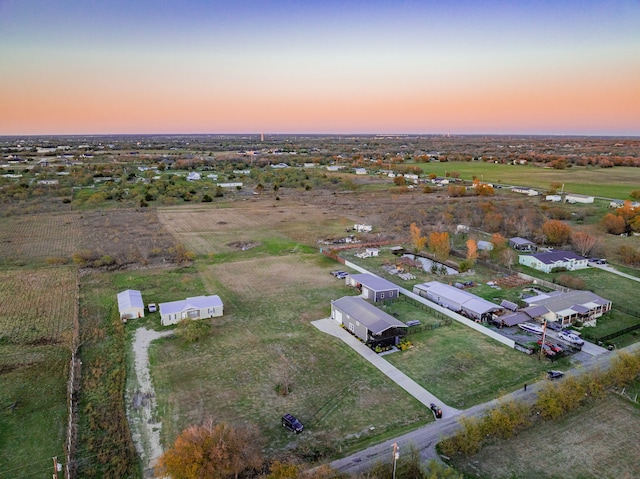 aerial view at dusk featuring a rural view