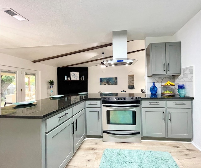 kitchen featuring lofted ceiling with beams, electric stove, dark stone countertops, kitchen peninsula, and island exhaust hood