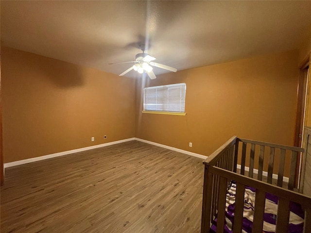 unfurnished bedroom featuring wood-type flooring and ceiling fan