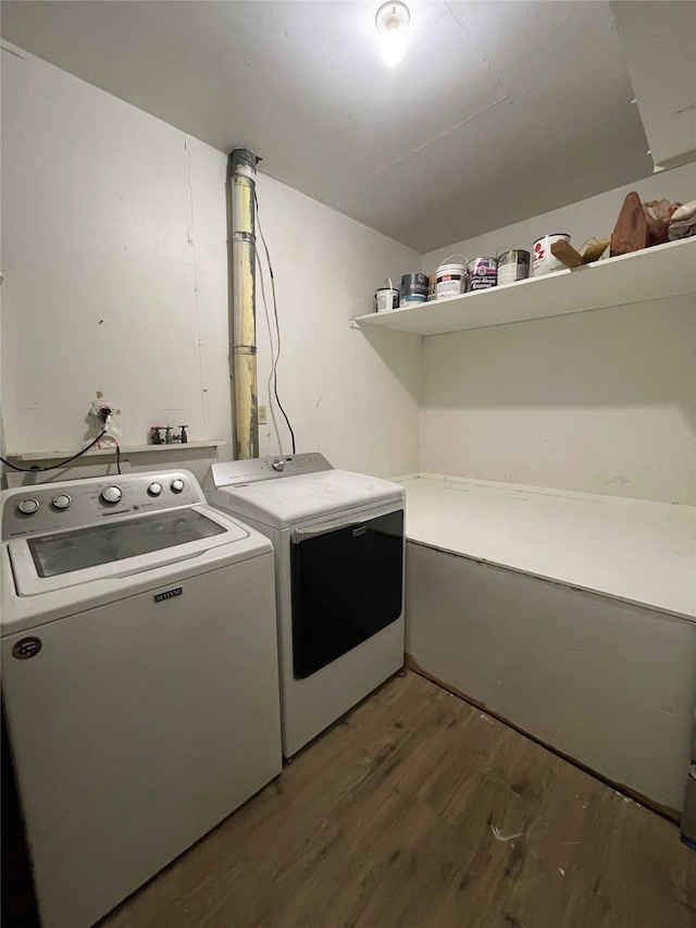 laundry room with dark hardwood / wood-style floors and washing machine and clothes dryer