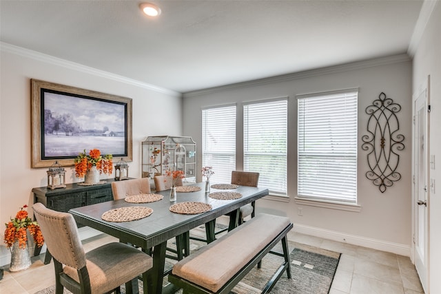 dining room featuring light tile patterned floors and ornamental molding