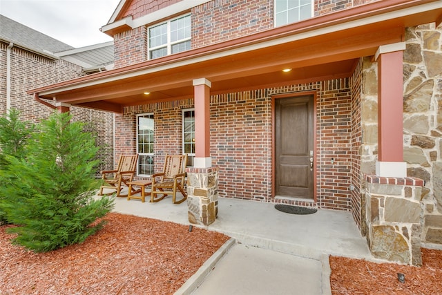 view of exterior entry with covered porch