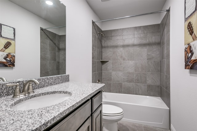 full bathroom featuring vanity, toilet, and tiled shower / bath