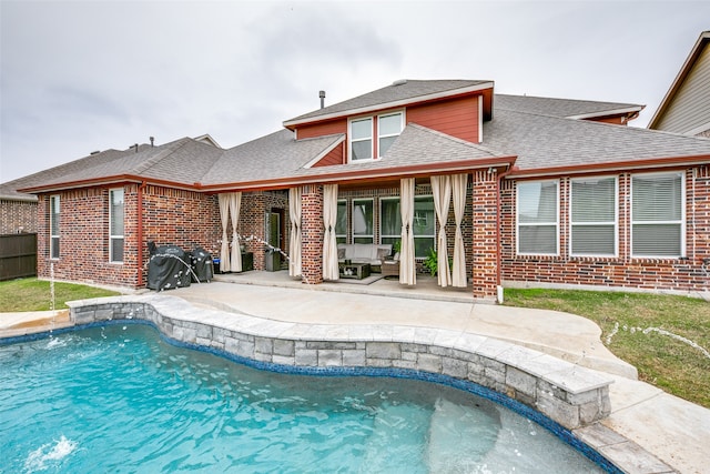 view of swimming pool featuring a patio area, pool water feature, and outdoor lounge area