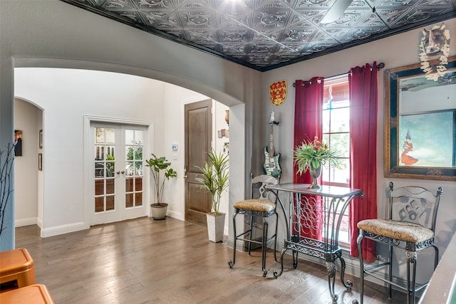 sitting room with a wealth of natural light, french doors, and wood-type flooring