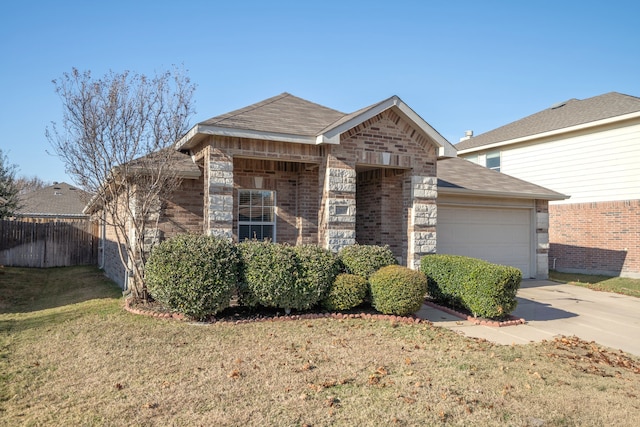 view of front of property with a front lawn and a garage