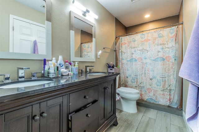 bathroom featuring vanity, curtained shower, and toilet